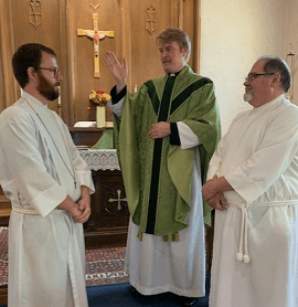Acolytes receiving a blessing at St. Andrew's